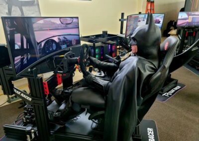 Archangel racing simulator in office with Batman test driving